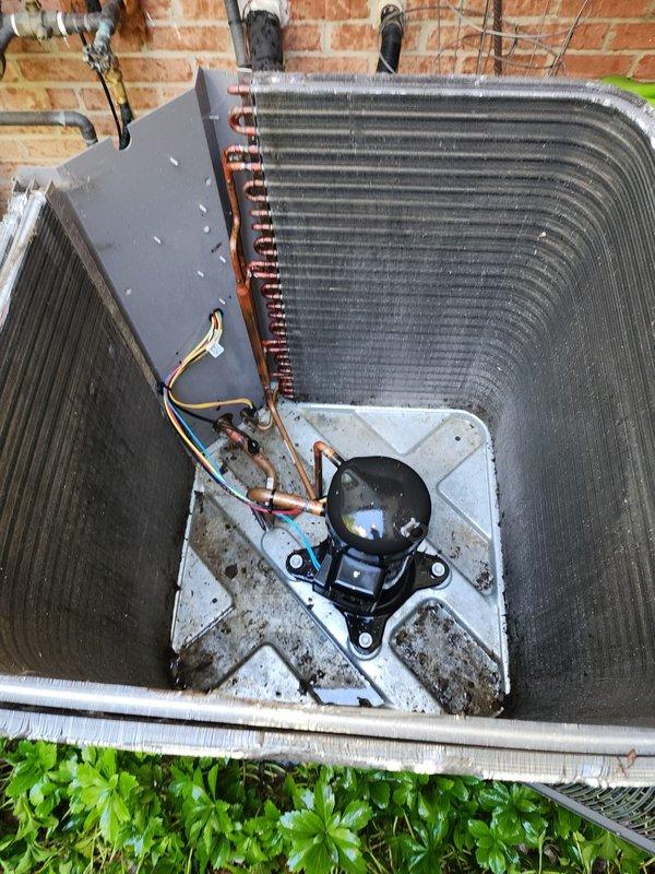 Completed scheduled cooling system maintenance on outdoor air conditioning condenser unit. Performed comprehensive inspection of compressor, refrigerant lines, and condenser coils, noting accumulation of dirt, debris, and environmental buildup on exterior fins and coil surfaces. Unit operational with all components functioning properly upon completion of routine preventive maintenance service.