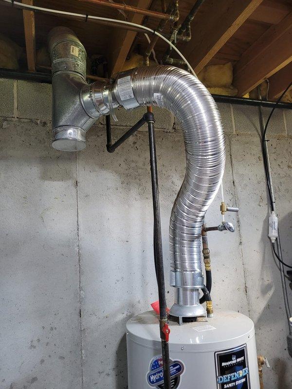 Completed installation of new Lennox furnace system with S40 smart thermostat in residential utility room. Removed existing bottom box as specified, established proper venting through exterior wall using PVC piping, and verified all connections for safe operation. System tested and confirmed operational upon completion.