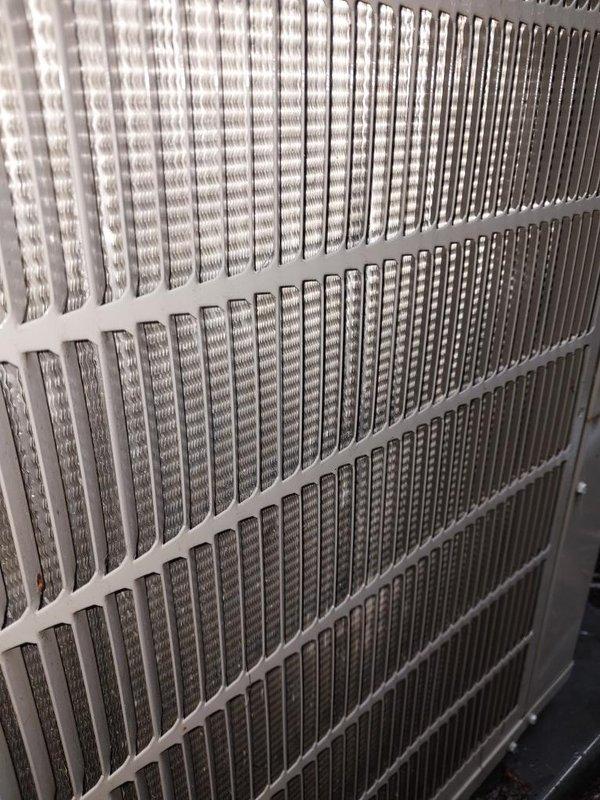 Completed comprehensive cooling system maintenance inspection on residential air conditioning unit. Verified evaporator coil condition showing clean, properly functioning fins with no debris accumulation or damage across all three sections of the heat exchanger assembly. Inspected condensing unit components including compressor, refrigerant lines, and drainage system, noting proper water evacuation through drain pan with no blockages present. All system components operating within normal parameters with no immediate service needs identified.