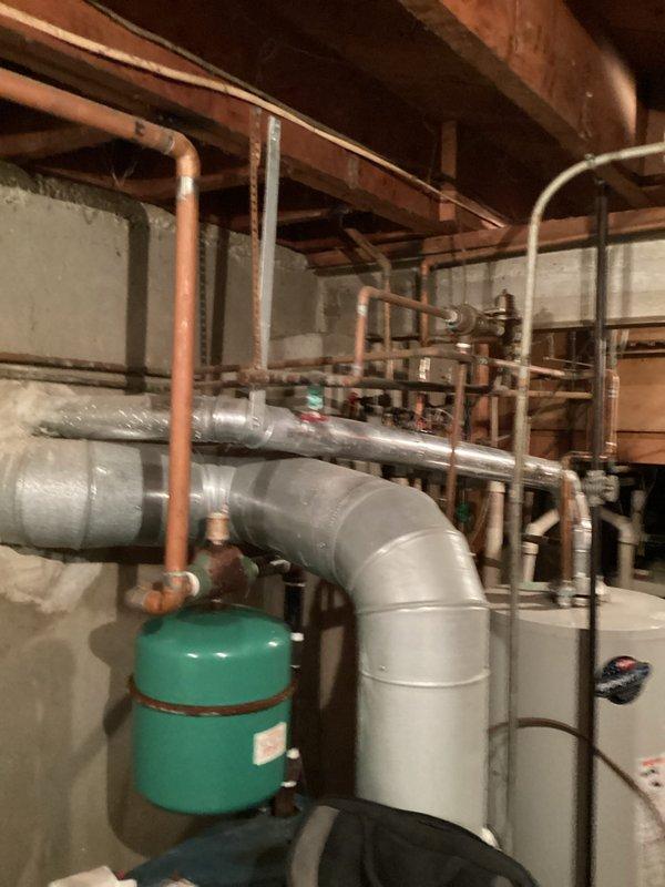 Conducted comprehensive site assessment for boiler system replacement in residential mechanical room. Documented existing heating infrastructure including aged copper piping network, expansion tank, zone valves, and associated HVAC ductwork to provide accurate equipment sizing and installation scope for new boiler system estimate.