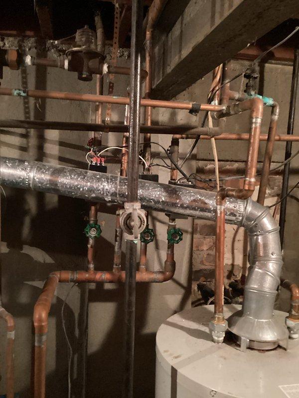 Conducted comprehensive site assessment for boiler system replacement in residential mechanical room. Documented existing heating infrastructure including aged copper piping network, expansion tank, zone valves, and associated HVAC ductwork to provide accurate equipment sizing and installation scope for new boiler system estimate.