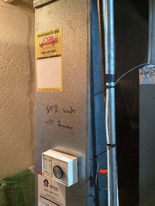 Completed furnace replacement estimate for residential basement installation. Evaluated existing dark-colored furnace unit with white PVC venting system, water heater, and electrical panel configuration in mechanical room. Documented current HVAC system layout including ductwork, piping arrangements, and thermostat controls for unit 404 to provide comprehensive replacement quote.