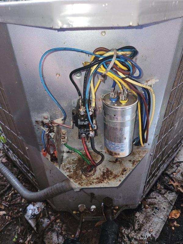 Completed routine cooling season maintenance on outdoor AC condensing unit. Performed comprehensive inspection of electrical components including capacitor, contactor, and wiring connections; all components found operating within normal parameters. Cleaned condenser coil fins and fan assembly, removing accumulated debris and surface contamination from outdoor exposure.