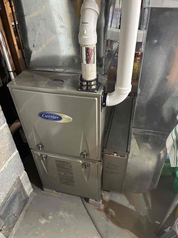 Performed semi-annual gas furnace tune-up service. Conducted electrical testing with multimeter (SC680) checking microamp readings (3.8 μA) indicating proper flame sensing operation. Inspected Carrier furnace system including venting, PVC exhaust/intake pipes, and condensate drainage. All components functioning properly with no issues identified.