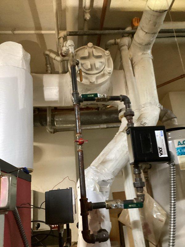 Performed comprehensive tune-up on heating system, finding significant dirt accumulation affecting efficiency. Cleaned heat exchanger components, removing built-up debris from fins and radiator elements. Inspected plumbing connections and control valves in utility area, noting some minor corrosion at connection points requiring monitoring.