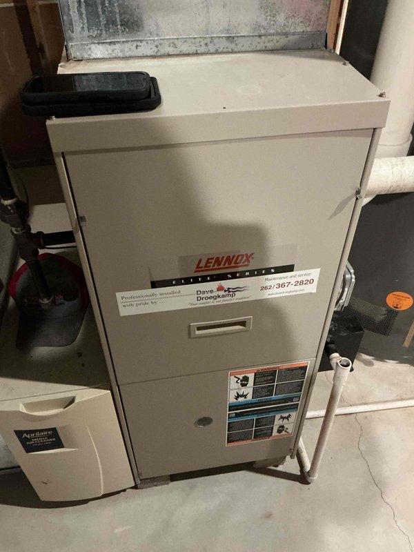 Performed scheduled winter maintenance tune-up on a Lennox Elite Series furnace with attached Aprilaire humidifier. Unit was functioning normally with no operational issues identified. Documented water damage on ceiling surface with visible discoloration and potential mold growth that requires attention.