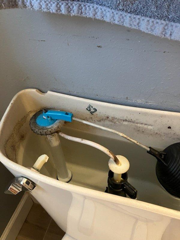 Responded to service call for multiple bathroom issues. Diagnosed and replaced broken toilet trip lever that was causing flush failure. Visual inspection of tank interior showed normal mineral deposits and functioning components after repair.