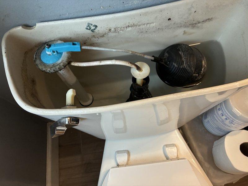 Responded to service call for multiple bathroom issues. Diagnosed and replaced broken toilet trip lever that was causing flush failure. Visual inspection of tank interior showed normal mineral deposits and functioning components after repair.