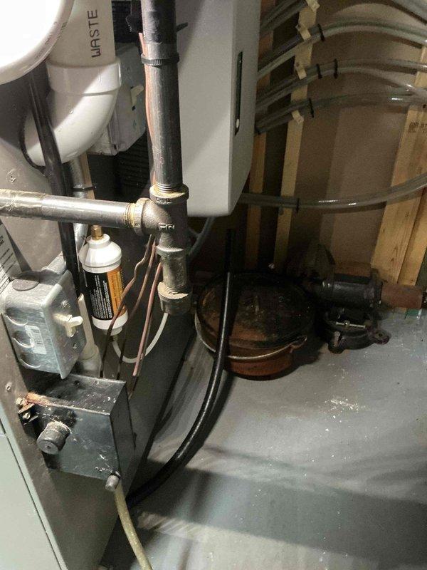 Responded to customer complaint of water leakage from furnace. Diagnosed issue as disconnected drain hose from steam humidifier. Reconnected the hose and secured it with a hose clamp to prevent future leakage.