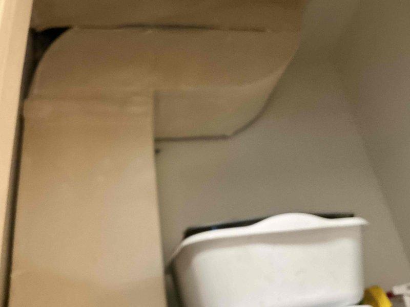 Conducted assessment of mechanical room containing water heater tank (labeled "MASTER BATHROOM") mounted on wooden structural framing in crawlspace area. Inspected surrounding environment for potential ductwork installation requirements, noting current structure conditions and clearances for future HVAC system integration.