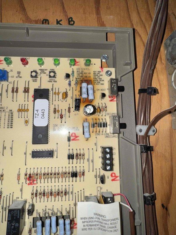 Responded to no heat call for aging HVAC system (10+ years). Diagnosed faulty circuit board in Zone-Artic control unit with several failed capacitors and damaged electrical components. Replaced control board and verified proper system operation. System now heating correctly with all zones functioning as designed.