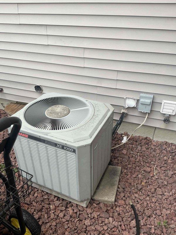Performed inspection of current HVAC system, revealing an aging Trane XE 1000 outdoor unit showing significant dust accumulation and potential corrosion damage. The indoor furnace unit exhibited extensive dirt buildup, possible water damage at base, and concerning signs of rust/corrosion at joints. Recommended full system replacement due to age, visible deterioration, and declining efficiency.