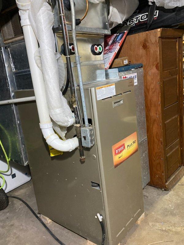 Performed a comprehensive tune-up on a Bryant Plus 90 residential furnace system. Inspected and cleaned interior components including the blower motor, gas valve assembly, and circuit boards. All electrical connections were checked and tightened, and the ventilation system including PVC pipes was examined for proper function and airflow.