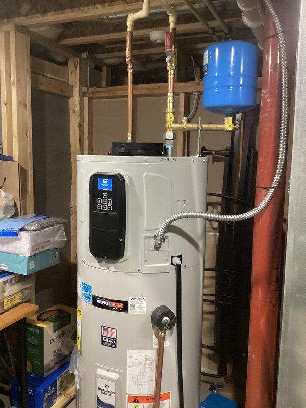 Installed and commissioned a high-efficiency heat pump water heater with digital controls in basement utility area. Connected unit to existing plumbing system including installation of expansion tank, PVC piping, and proper valving. Completed all electrical connections and verified system operation before leaving site.
