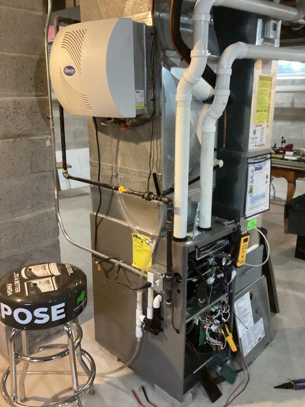 Performed comprehensive tune-up on furnace system with humidifier. Inspected internal components and electrical connections after removing access panel. Verified secure installation of drainage pipes and checked mechanical connections including hose clamps on condensate line. All components functioning properly with no issues detected.