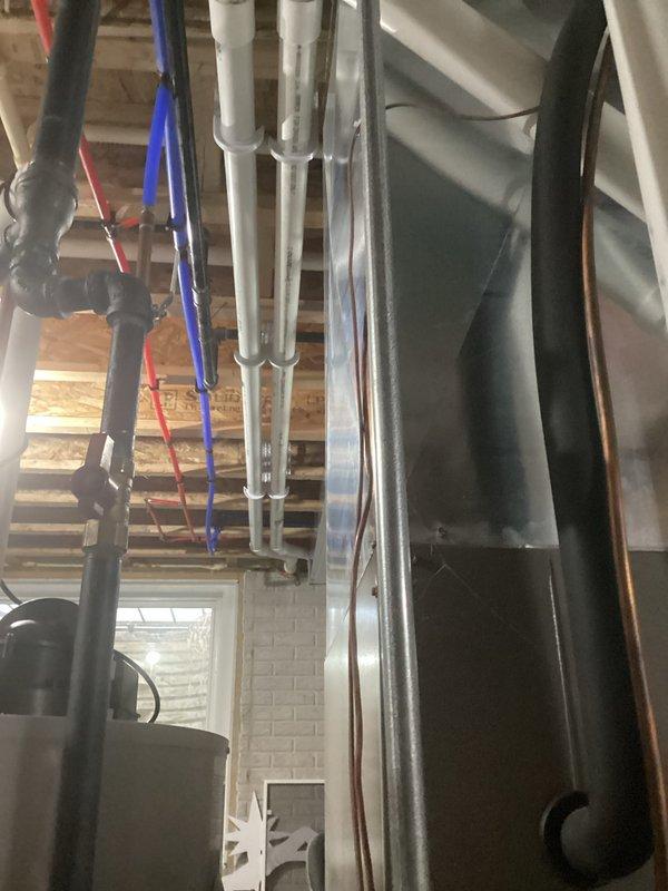 Performed comprehensive HVAC tune-up service, inspecting basement/utility room systems including PVC drainage components and associated ductwork. Verified proper installation of condensate lines and checked connections between main system components, ensuring all plumbing and ventilation pathways were free from obstructions and functioning according to manufacturer specifications.