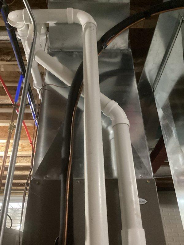 Performed comprehensive HVAC tune-up service, inspecting basement/utility room systems including PVC drainage components and associated ductwork. Verified proper installation of condensate lines and checked connections between main system components, ensuring all plumbing and ventilation pathways were free from obstructions and functioning according to manufacturer specifications.