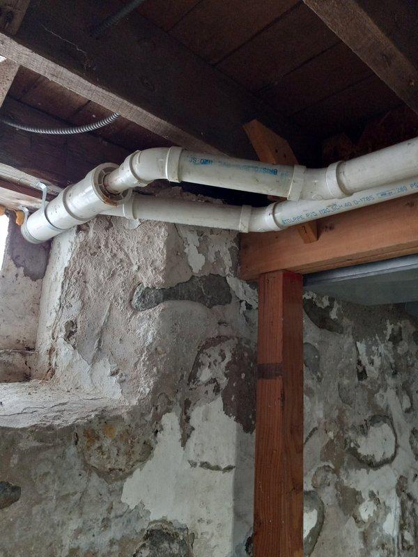 Inspected Armstrong furnace system in basement utility area. Evaluated PVC venting/condensate lines and connection to existing ductwork. Noted wall surface deterioration near plumbing installation that may require attention to prevent moisture-related issues affecting HVAC system performance.