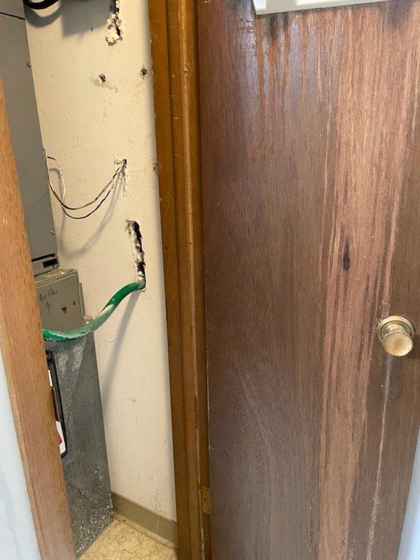 Responded to a no-heat call for an older HVAC system. Inspected the thermostat (Honeywell model) which was actively calling for heat with a 9° differential between room temperature (56°F) and set point (65°F). Investigation of the utility area revealed multiple exposed wires and incomplete electrical connections which were identified as the source of system failure. Repaired wiring connections to restore proper operation of the heating system.