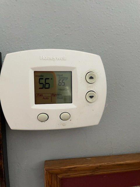 Responded to a no-heat call for an older HVAC system. Inspected the thermostat (Honeywell model) which was actively calling for heat with a 9° differential between room temperature (56°F) and set point (65°F). Investigation of the utility area revealed multiple exposed wires and incomplete electrical connections which were identified as the source of system failure. Repaired wiring connections to restore proper operation of the heating system.
