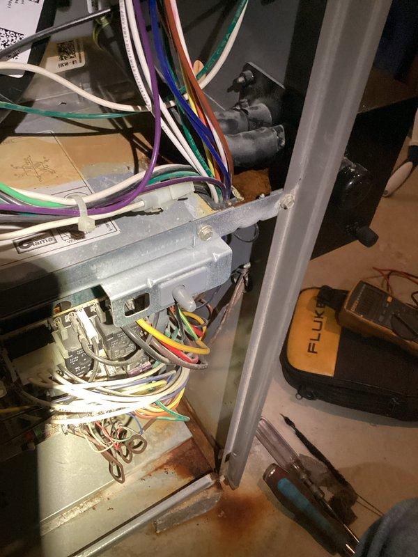 Completed tune-up maintenance on residential HVAC system including inspection of electrical control components and wiring connections. Checked all terminal connections and inspected wiring integrity using Fluke meter for voltage testing. Examined mechanical infrastructure in basement utility area, including assessment of system insulation and proximity to other utilities (water heater and Generac backup system).