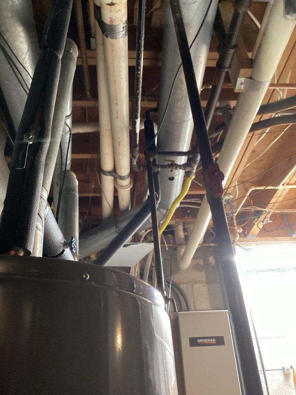 Completed tune-up maintenance on residential HVAC system including inspection of electrical control components and wiring connections. Checked all terminal connections and inspected wiring integrity using Fluke meter for voltage testing. Examined mechanical infrastructure in basement utility area, including assessment of system insulation and proximity to other utilities (water heater and Generac backup system).