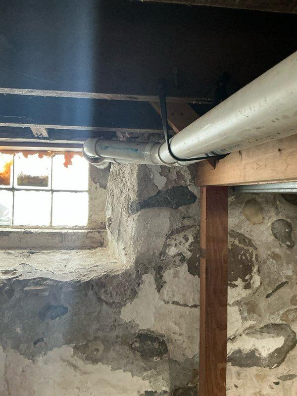 Completed comprehensive inspection of existing HVAC system in basement utility area, documenting deteriorating foundation walls with visible moisture damage. Captured photographic evidence of current furnace installation adjacent to water heater, noting space constraints and necessary considerations for equipment replacement. Prepared estimate for full system replacement due to age and condition of current unit.