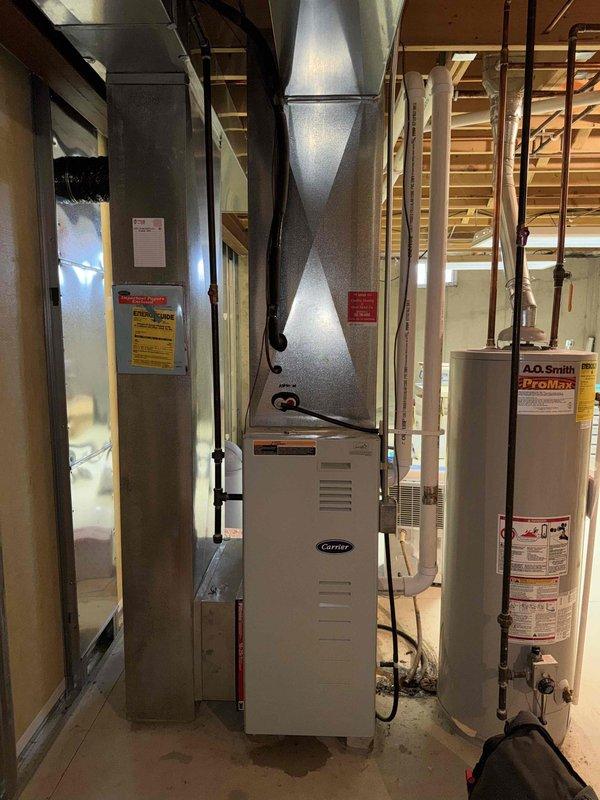 Performed annual maintenance service on Carrier furnace in mechanical room. Conducted combustion analysis with Sauermann gas analyzer, measuring O2 and CO2 levels (CO2 at 0.96%) to verify proper combustion efficiency. System is operating correctly with no issues detected.