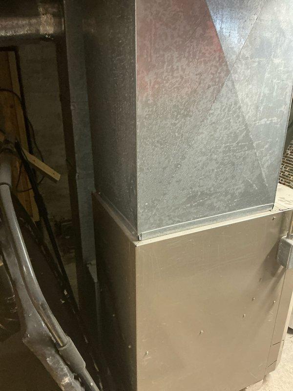 Performed inspection of electrical service panel and examined existing HVAC equipment installation in utility area. Documented condition of circuit breaker panel with approximately 20 breakers and associated directory for reference during system replacement planning. Evaluated current ductwork configuration and equipment housing to determine appropriate specifications for replacement unit.