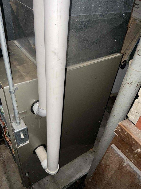 Conducted comprehensive assessment of existing HVAC system in residential basement requiring replacement. Inspection revealed aging furnace unit with associated PVC intake/exhaust venting and electrical connections. Evaluated ceiling infrastructure access points for potential ductwork modifications to improve system efficiency.