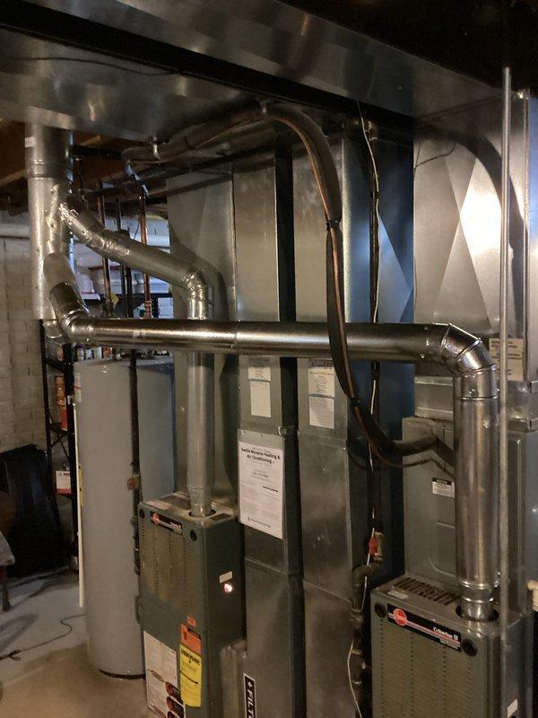 Completed dual-system furnace inspection in mechanical room. Visually inspected Ruud furnace units, associated ductwork, and connections. Both systems appeared to be in normal working condition with no visible damage or abnormalities noted. Confirmed proper installation of ventilation system and verified safety warning labels were intact and visible.