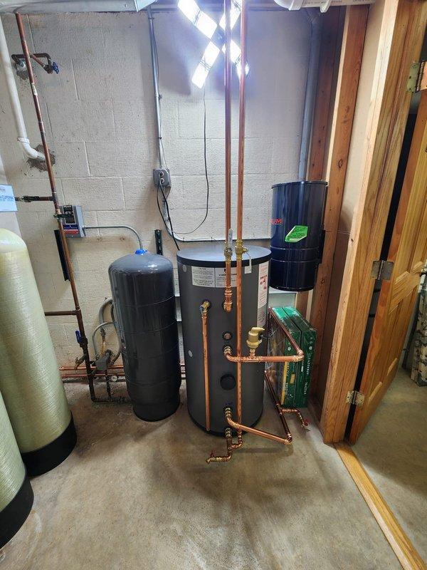 Completed installation of a new high-efficiency boiler system with integrated digital controls. Installed proper copper piping connections throughout, including expansion tank, pressure tank, and dual green circulator pumps. System includes water treatment equipment (softener/filtration system) to protect boiler and ensure optimal performance and longevity.