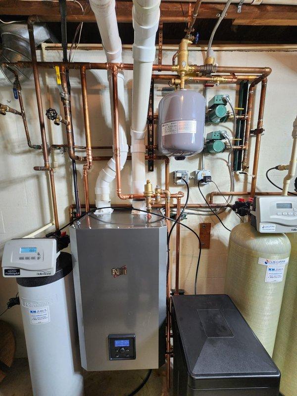 Completed installation of a new high-efficiency boiler system with integrated digital controls. Installed proper copper piping connections throughout, including expansion tank, pressure tank, and dual green circulator pumps. System includes water treatment equipment (softener/filtration system) to protect boiler and ensure optimal performance and longevity.