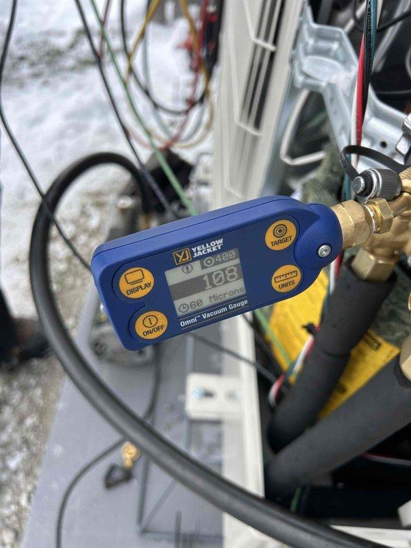 Successfully installed a Mitsubishi H2i heat pump system with the outdoor unit properly mounted on a concrete pad and secured to the residence. System was evacuated to 108 microns as verified with Yellow Jacket digital vacuum gauge, ensuring proper dehydration of the refrigerant circuit before commissioning. All electrical connections were completed according to manufacturer specifications with required safety measures implemented.