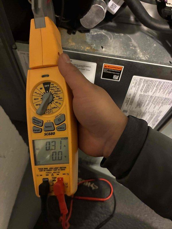 Conducted routine tune-up on Lennox furnace system, performing electrical diagnostics with SC660 multimeter showing 83.1V reading at test point. Inspected PVC venting pipes, electrical connections, and copper line set - all components found to be in good working condition with no issues detected.