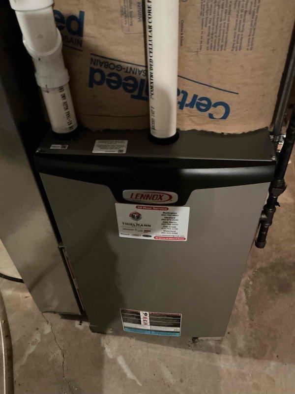 Performed annual tune-up on customer's Lennox HVAC system located in basement utility area. Inspected unit connections, checked PVC ventilation pipes, and verified proper installation of insulation materials around system components. Unit was found to be in normal working condition with no visible damage or operational issues.