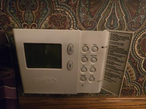 Inspected non-operational thermostat on an aging Lennox HVAC system. Found display was blank with no power. Replaced faulty thermostat batteries, tested system cycling through heat mode, and verified proper operation. Instructed customer on basic thermostat programming using the manual.