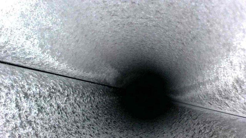 Conducted routine HVAC tune-up service, with detailed inspection of the ductwork system. Examined internal duct surfaces, noting normal accumulation of dust on concrete surfaces with intact seams and joints. System appears to be functioning properly with no structural issues observed in ventilation passages.