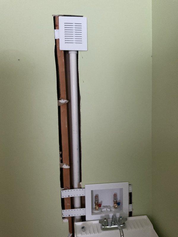 Completed installation of a utility sink with chrome faucet in customer's space, connecting supply lines to existing hot and cold water valves. Verified proper seating of sink on metal legs and ensured access panel remains functional for future maintenance needs.