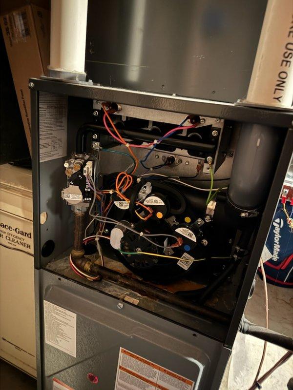 Performed diagnostic inspection on residential furnace system with access panels removed. Evaluated internal wiring connections, circuit boards, gas valve assembly and control components. Inspected integrated Space-Gard air cleaner unit and confirmed proper installation of condensate drain system with PVC piping.