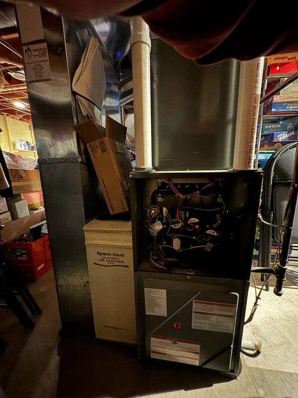Performed diagnostic inspection on residential furnace system with access panels removed. Evaluated internal wiring connections, circuit boards, gas valve assembly and control components. Inspected integrated Space-Gard air cleaner unit and confirmed proper installation of condensate drain system with PVC piping.