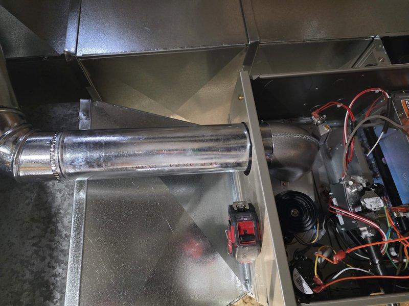 Successfully completed installation of a new furnace with proper connection of all ductwork and electrical components. Installed system includes galvanized sheet metal ducting with sealed joints and a horizontal exhaust vent pipe. Final inspection confirmed proper wiring of control modules and all connections are secure with system functioning as designed.