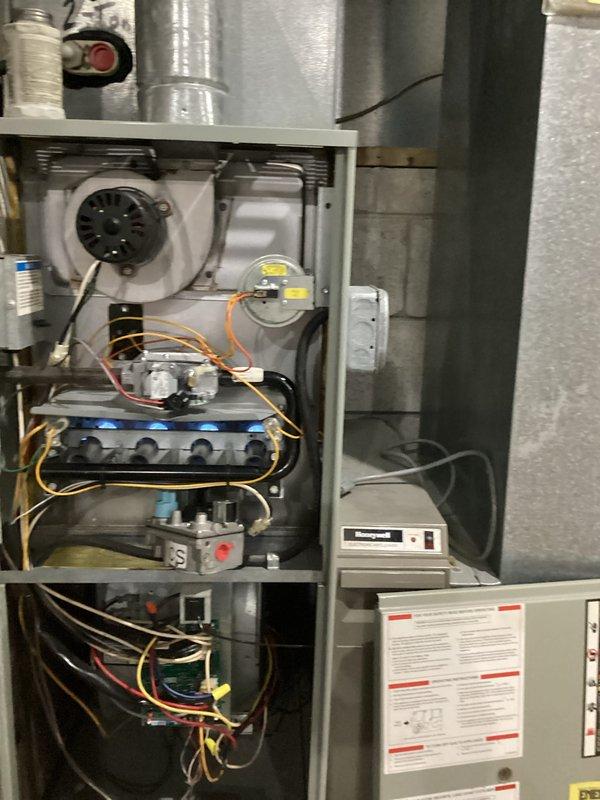 Diagnosed and serviced 10+ year old Honeywell furnace that was not producing heat. Upon inspection, identified issues with the gas valve assembly and ignition sequence. Cleaned flame sensor, reset control board, and verified proper gas flow through manifold. After repairs, tested system operation with all burners showing proper blue flame pattern and confirmed normal heat cycle completion. Unit now operating at expected efficiency.