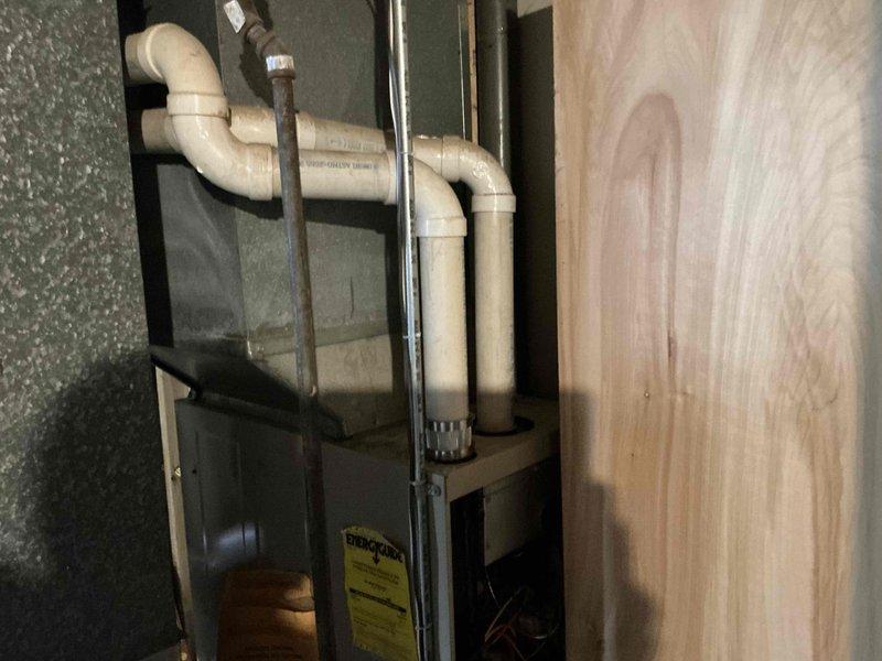 Completed replacement of residential HVAC system, installing new furnace unit with proper PVC drainage system in utility closet. Configured professional plumbing trap configuration with appropriate S-curve to ensure proper condensate drainage and prevent backflow issues.