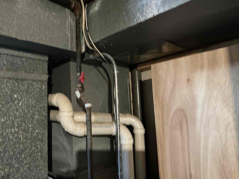 Completed replacement of residential HVAC system, installing new furnace unit with proper PVC drainage system in utility closet. Configured professional plumbing trap configuration with appropriate S-curve to ensure proper condensate drainage and prevent backflow issues.