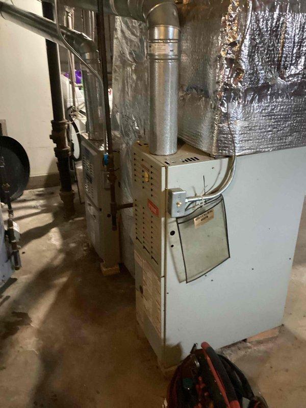 Responded to a no-heat call for a residential system with an aging furnace (10+ years). Upon inspection of the unit located in the basement, found the flame sensor covered with carbon deposits causing intermittent flame failure. Cleaned the flame sensor thoroughly, tested ignition sequence, and verified proper operation through multiple heating cycles. System is now functioning normally with consistent flame detection and proper heat output.