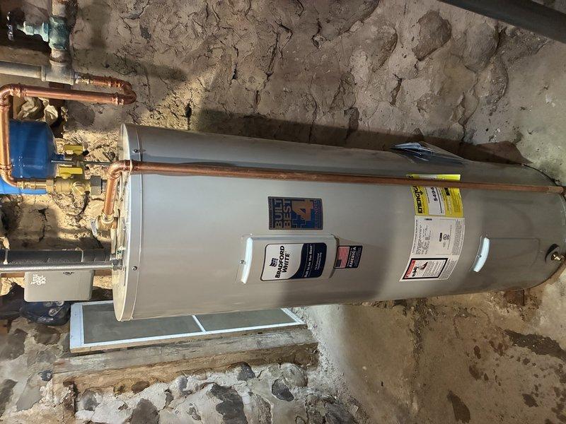 Completed installation of comprehensive water treatment system consisting of ProfessionalH2O water softener units and a Capital SOFTENER tank in basement utility area. System includes Solution Series electronic control panels with digital displays for monitoring water conditions. Connected all components to existing copper supply lines and verified proper function of all control units, including Hellenbrand pump components. Ensured integration with existing residential water heater and pressure tank for complete household water management solution.