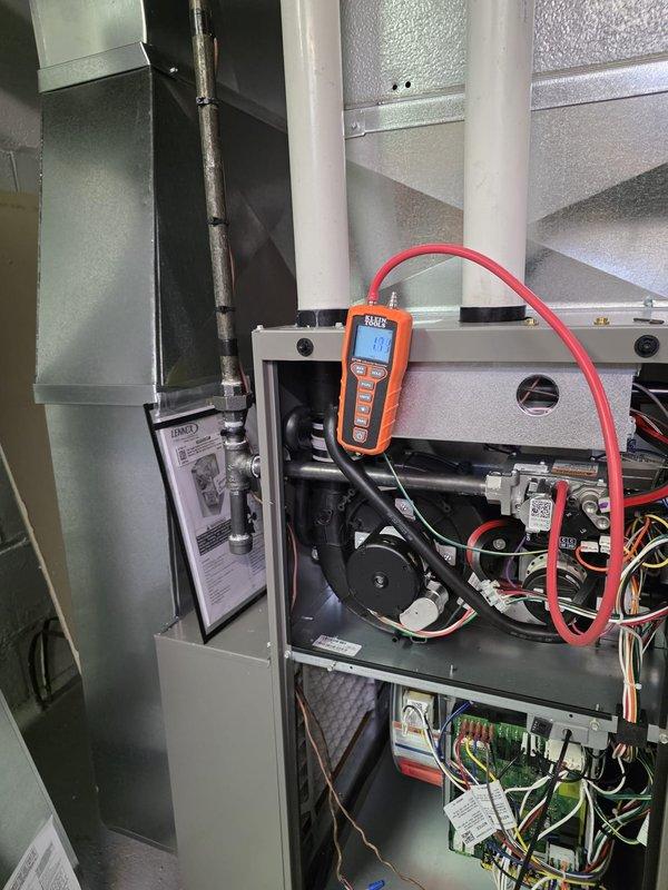 Completed installation of new residential furnace with proper gas pressure verification (13.3" WC reading confirmed with digital manometer). System includes standard blower assembly and control board connections. Installation included connection to existing ductwork system and coordination with water heater venting for proper clearances and airflow. All electrical components wired according to manufacturer specifications and system tested for normal operation.