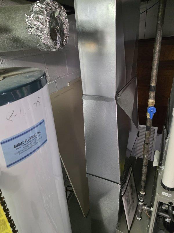 Completed installation of new residential furnace with proper gas pressure verification (13.3" WC reading confirmed with digital manometer). System includes standard blower assembly and control board connections. Installation included connection to existing ductwork system and coordination with water heater venting for proper clearances and airflow. All electrical components wired according to manufacturer specifications and system tested for normal operation.