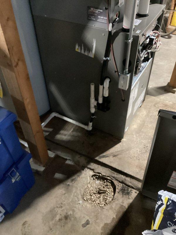 Completed installation of a new gray furnace unit in basement utility area, connecting required white PVC ventilation pipes and properly mounting the system to existing framing. Final static pressure testing with MA-line Micromanometer (MA-TDSSA) confirmed optimal system performance at 16.5 WC.